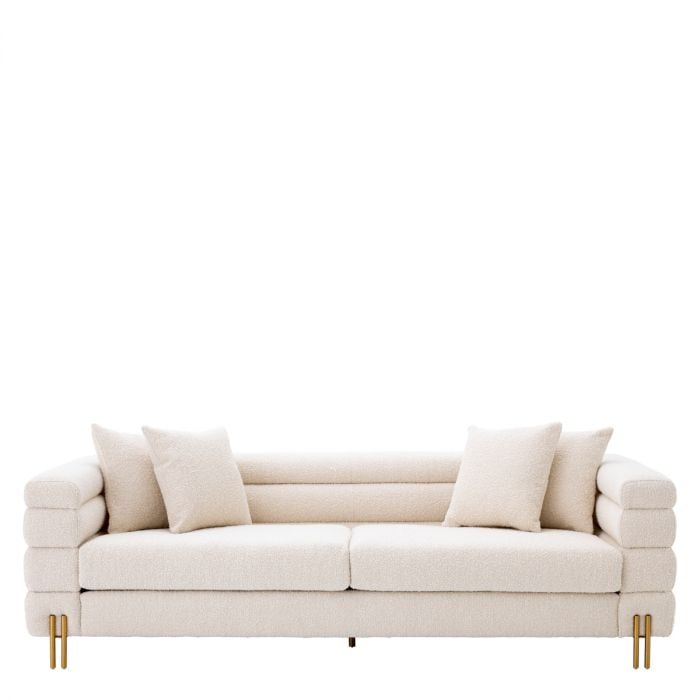A modern, elegant white sofa with two pillows on either side, featuring a minimalist design and stylish gold legs.